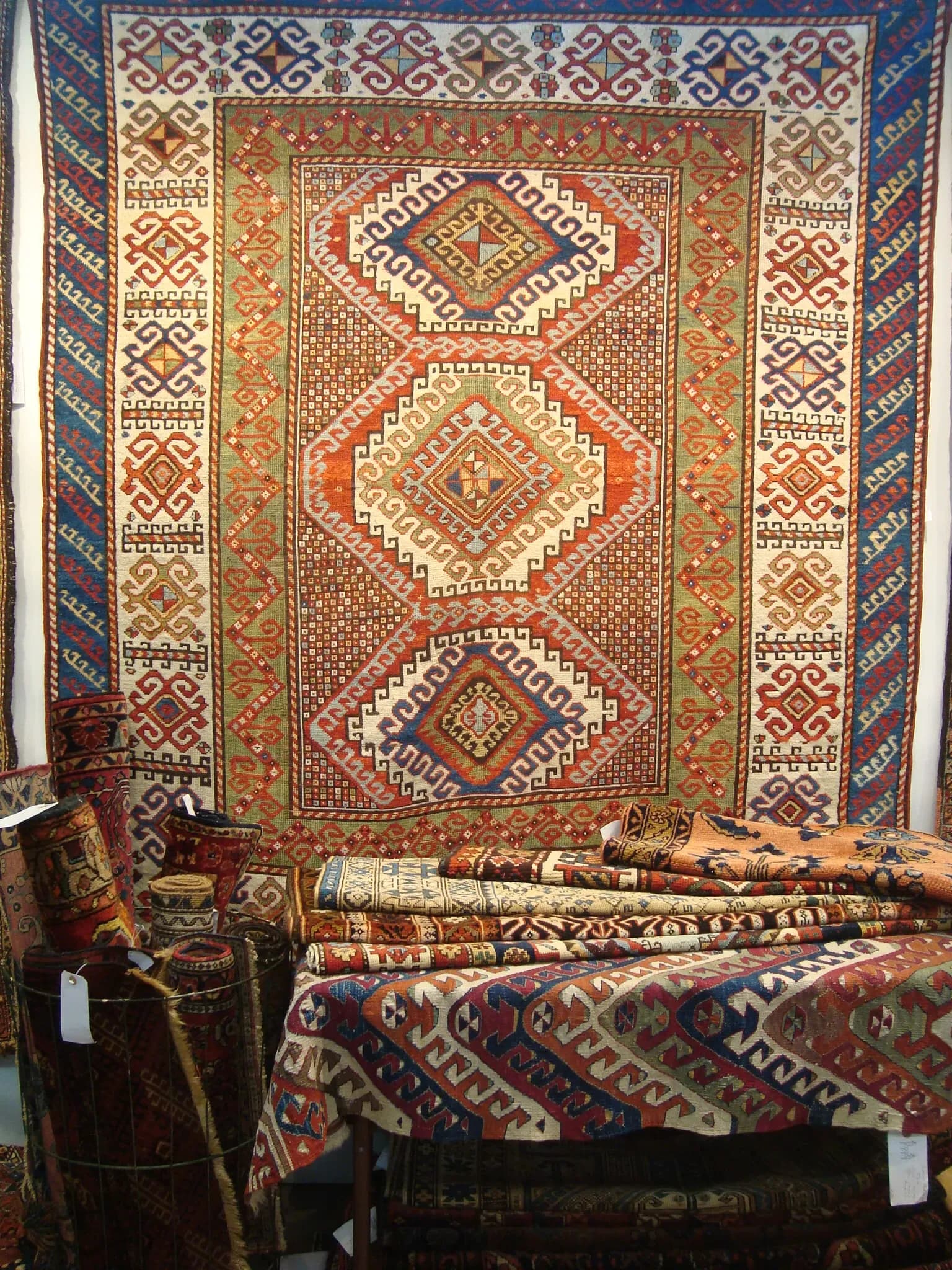 Antique Caucasian Kazak rug featuring bold geometric patterns in red and blue